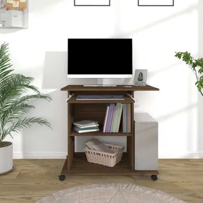 A computer desk with a monitor, keyboard, and storage shelves, set in a room with a plant.