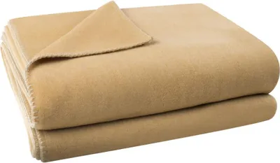 A folded camel-colored fleece blanket is shown.