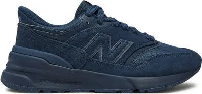 A side view of a navy blue New Balance sneaker against a white background.