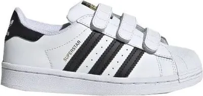 A white and black Adidas Superstar sneaker with velcro straps.
