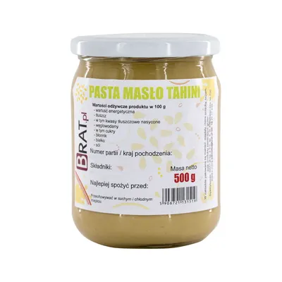 A jar of tahini paste on a white background.