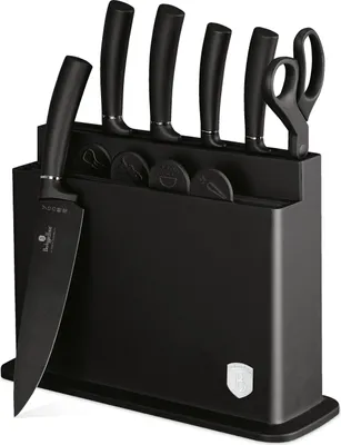 A black knife block with several knives and scissors inserted.