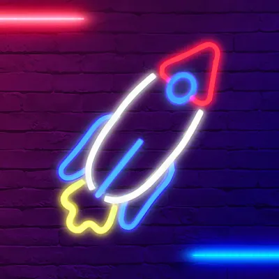 A neon rocket sign against a brick wall.