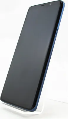 A black smartphone with a blue frame is displayed on a white stand against a white background.