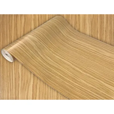 A roll of wood-grain patterned contact paper is shown unrolling onto a surface of the same pattern.
