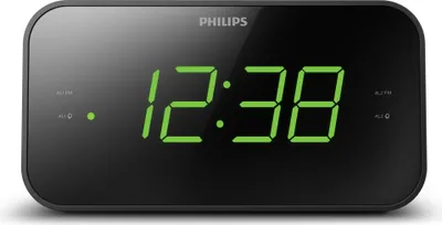 A digital alarm clock with a green LED display showing the time.