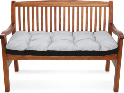 A wooden bench with a gray cushion.