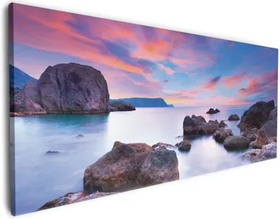 Produktbild von Wallario Premium Leinwandbild Seelandschaft in blau und rot mit großen Felsen in Größe 60 x 150 cm