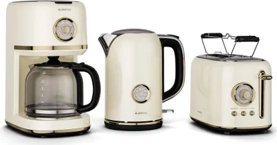 A cream-colored coffee maker, kettle, and toaster set with gold accents are displayed against a white background.