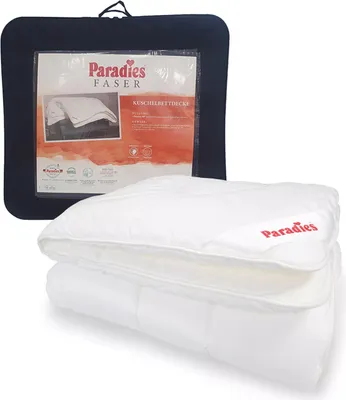A folded white duvet is shown in front of its dark blue packaging, which displays product information.
