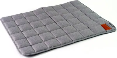A gray quilted dog mat with a small brown tag on the corner, isolated on a white background.