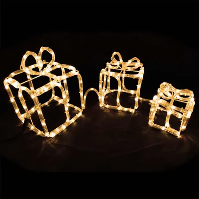 Three illuminated gift boxes arranged in a line against a black background.