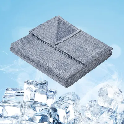 A folded gray blanket is shown on a light blue background with ice cubes in the foreground.