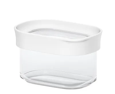 A clear studio shot of a clear plastic food storage container with a white lid.