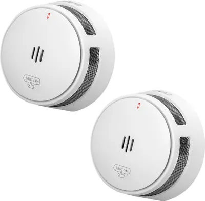 Two white smoke detectors are shown against a white background.