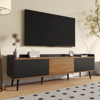 A modern living room scene featuring a TV stand with a television mounted above it.