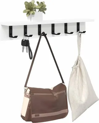 A white shelf with black hooks mounted on a white wall. Two bags and a set of keys are hanging from the hooks. A small potted plant sits on the shelf.