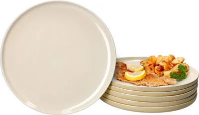 A stack of plates, with one plate in the foreground and a stack of plates with food on top in the background.