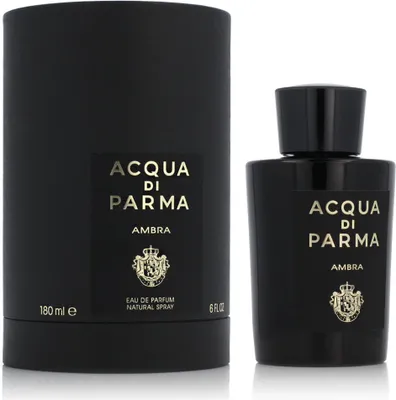 A black perfume bottle and its cylindrical packaging are displayed against a white background.