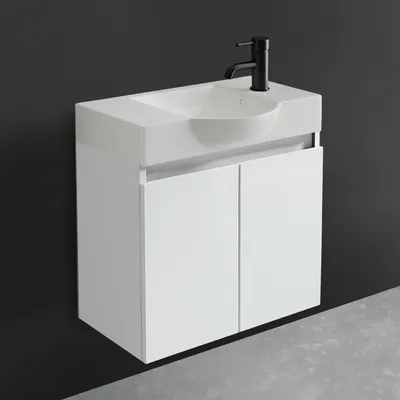 A white bathroom vanity with a sink and black faucet against a dark gray wall and a gray floor.
