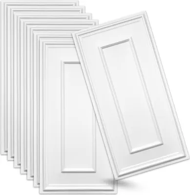 A stack of white 3D wall panels with a decorative embossed pattern.