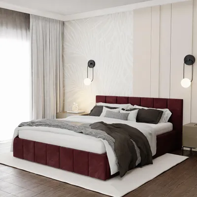 A bedroom scene featuring a burgundy upholstered bed.