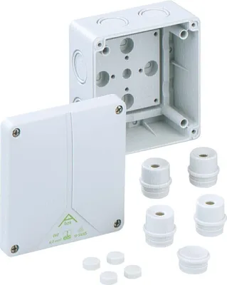 A white electrical junction box with its lid detached, shown with several small white caps and threaded connectors.