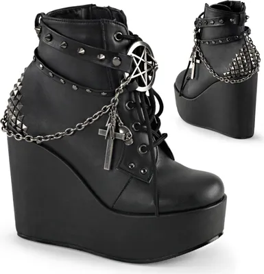 A pair of black platform wedge boots with gothic-style embellishments.
