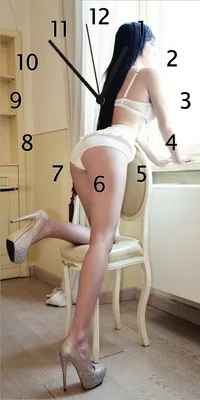 Produktbild von Wallario Design Wanduhr bedruckt, Größe 30 x 60 cm, Motiv: Sexy Dessous - Junge Frau mit eleganten Beinen am Fenster