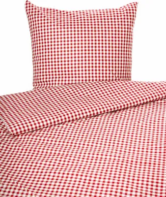 A close-up view of red and white checkered bedding, including a pillow and a duvet cover.