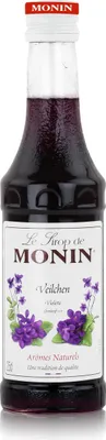 A bottle of Monin syrup with purple flowers on the label.