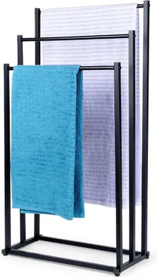 A black metal towel rack with three bars, holding three different colored towels.