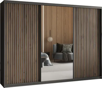 A bedroom scene reflected in a mirrored wardrobe door, showing a bed and a chair.