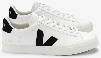 A pair of white VEJA sneakers with black accents.