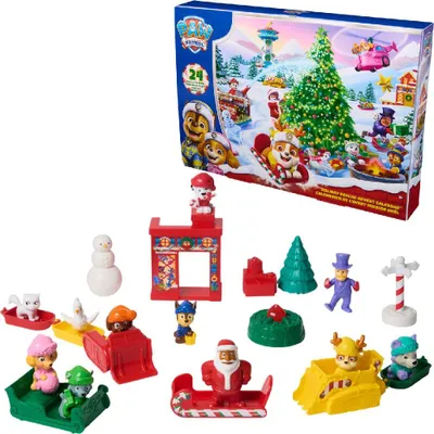 A collection of Paw Patrol advent calendar toys arranged in front of the advent calendar box.