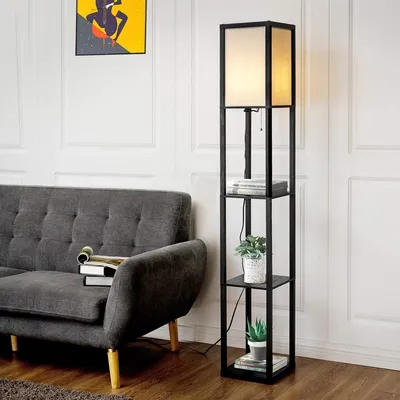 A modern living room scene with a grey sofa and a black floor lamp with shelves.