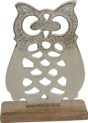 A silver owl figurine with cutouts, mounted on a wooden base.