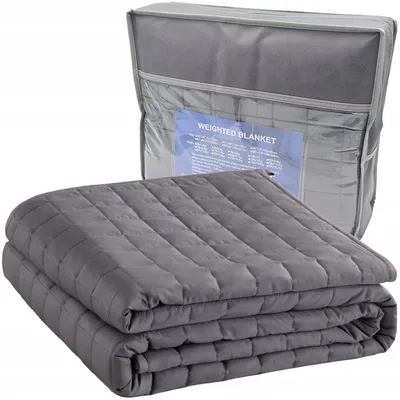 A folded weighted blanket is shown in front of its storage bag.