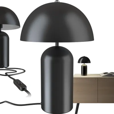A studio shot of a black mushroom-shaped table lamp.