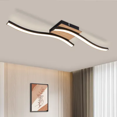 A modern ceiling light fixture with curved LED lights and a wood accent, mounted on a ceiling.