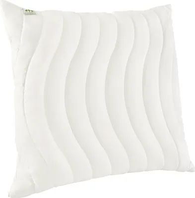 A white pillow with a wavy quilted pattern.