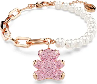 A close-up shot of a bracelet with a teddy bear charm.