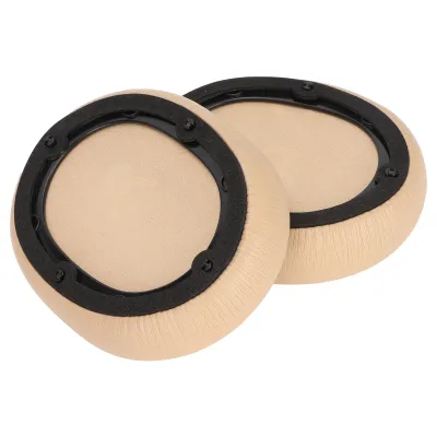 Two beige headphone ear pads with black trim are shown against a white background.