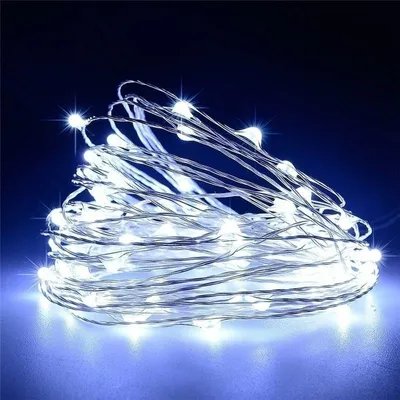 A coiled string of white LED lights against a dark blue background.
