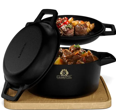 A black cast iron pot with a lid and a separate pan containing food, displayed on a wooden cutting board.