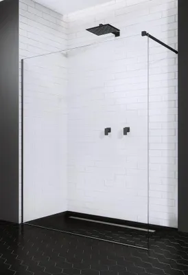 A modern shower enclosure with a black shower head and fixtures, set against a white tiled wall and black tiled floor.