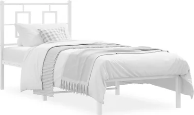 A white metal bed frame with a headboard, a mattress, and bedding.