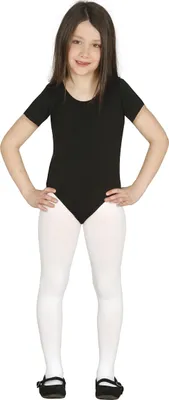 A young girl is posing in a studio setting, wearing a black leotard and white tights.