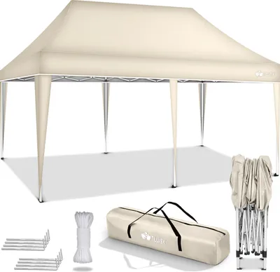 A beige pop-up canopy tent with its accessories laid out.