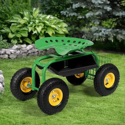 A green garden cart with a seat and storage bin sits on a grassy lawn with bushes and a stone wall in the background.